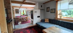 a living room with a blue couch and a dog at Dom Rodzinny w Niedźwiedzim Rogu- nad Śniardwami in Niedźwiedzi Róg +20 photos