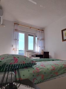 a bedroom with two beds and a window at River View Apartment Gospic in Gospić