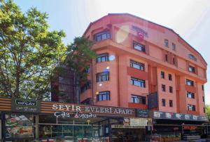 a tall orange building on a city street at Seyir Evleri DİVAN in Kayseri