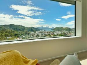 a window with a view of a city at Picton Hilltop Apartment in Picton