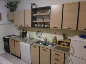 a kitchen with a sink and a dishwasher at Apartment Mireja in Pučišća