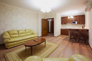 a living room with a couch and a table at ASAO-Apartments walking center zone in Lviv