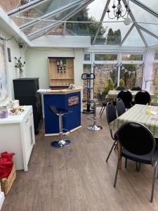 a conservatory with a table and chairs in it at The Rosefield in Weymouth