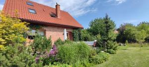 a brick house with a red roof at Dom Rodzinny w Niedźwiedzim Rogu- nad Śniardwami in Niedźwiedzi Róg