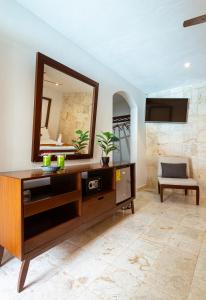 a bathroom with a vanity and a mirror at La Aurora Hotel Colonial in Valladolid