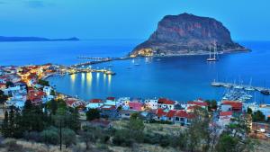 a view of a town with a mountain in the water at Ypatia Cozy Castle Suite Apartment with Loft in Monemvasia