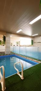 a swimming pool with two chairs in a building at HGA-Topacio-Spa in La Paz