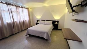 Cómodo y hermoso apartamento في Líbano: غرفة نوم فيها سرير وتلفزيون