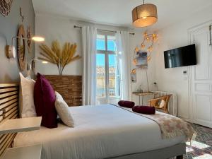 a bedroom with a large bed and a window at Casa-Belle Chambres d hotes in Sérignan