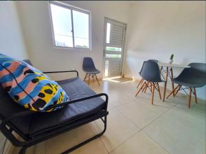 a living room with a couch and a table and chairs at Apartamento Privado Palomino in Palomino