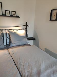 a bedroom with a bed with a white pillow at Altstadt Lübsche Straße in Wismar