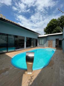 a swimming pool in the middle of a house at Hotel pousada maria Julia in Araguaína