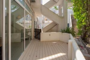 a hallway of a house with glass doors and stairs at Charming Principe Real perfect for Families in Lisbon