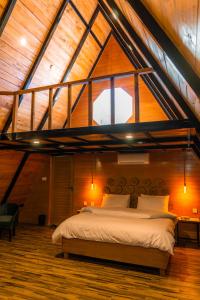 a bedroom with a large bed in a attic at Maple Resorts in Skardu