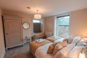 a bedroom with two beds and a window at The Jodrell Luxury Suites in Whaley Bridge