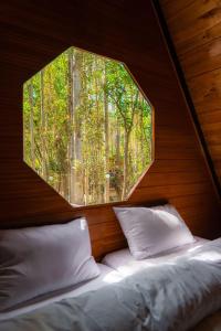 a room with two beds and a circular window at Maple Resorts in Skardu
