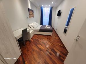 a small room with a bed and a desk in it at Vatican house 98 in Rome