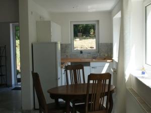 a kitchen with a table and chairs and a refrigerator at Majestic apartment in Werder in Werder