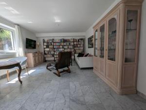 a room with a library with a couch and a chair at Majestic apartment in Werder in Werder