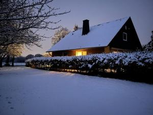 una casa con tetto ricoperto di neve accanto a un cortile di Quaint apartment in Soest a Soest