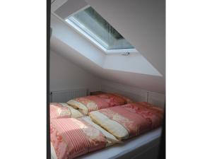 a bed in a small room with a skylight at in the Berghanghäus"l Obersalzberg in Berchtesgaden