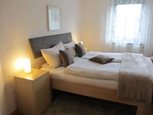 a bedroom with a bed with a candle on it at Nice apartment in Gersfeld in Gersfeld