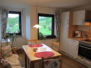 a living room with a table and a kitchen at Nice apartment in Gersfeld in Gersfeld