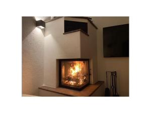 a fireplace with a fire in it in a room at Lively apartment in Bad Wiessee in Bad Wiessee