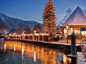 a christmas market with a christmas tree and a river at Lively apartment in Bad Wiessee in Bad Wiessee