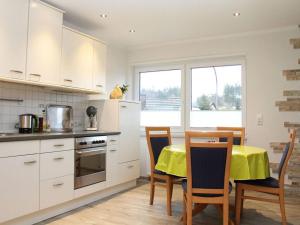 a kitchen with a table with a yellow table cloth on it at Nice apartment in Daun-Waldkönigen 