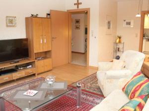 a living room with a couch and a tv at Nice apartment in Daun-Waldkönigen 