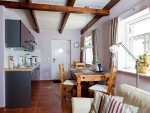 - une cuisine et une salle à manger avec une table et des chaises dans l'établissement Müller's apartment in the Nordermühle, à Pellworm