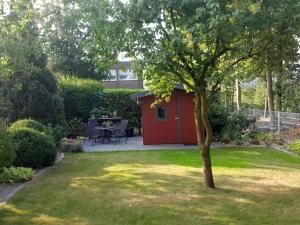 a red shed in the middle of a yard at Nice apartment in Neuenkirchen in Neuenkirchen