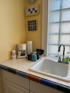 a kitchen counter with a sink and a window at Fountainview Inn in Indianapolis