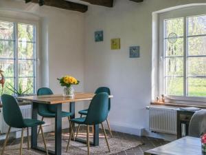 a dining room with a table and green chairs at Lovely apartment in Straelen in Straelen