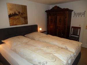 a bed in a bedroom with a wooden headboard at Lovely apartment in Berchtesgaden in Berchtesgaden