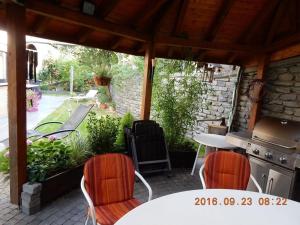 a patio with a table and chairs and a grill at Holiday apartment Moselle Panorama in Enkirch