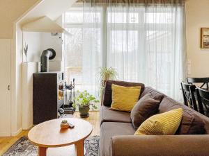 a living room with a couch and a table at Holiday home VÄDDÖ V in Väddö