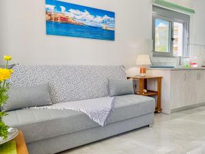 a living room with a couch and a kitchen at Newly Built House Steps from the Beach: Everything Within Walking Distance - Enjoy a Car-Free Stay in Agia Marina Nea Kydonias