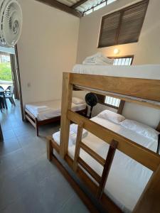 a room with three bunk beds in it at Cabaña Pazatiempo II Sapzurro in Sapzurro