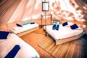Una habitación con 2 camas en una tienda en Lodg'ing Nature Camp Anjou NEW 2024, en Sainte-Gemme-sur-Loire