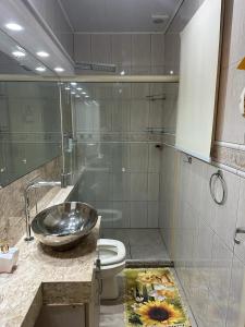 a bathroom with a sink and a toilet at Aluguel casa com piscina no centro em Torres/RS in Torres