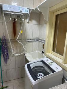 a small bathroom with a toilet and a sink at Aluguel casa com piscina no centro em Torres/RS in Torres +13 photos