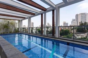 a swimming pool on the roof of a building at Domy in Sao Paulo