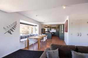 a dining room and living room with a table at Haka Lodge Taupo in Taupo