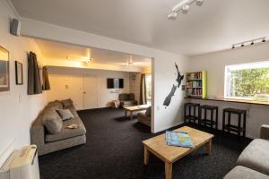 a living room with a couch and a table at Haka Lodge Taupo in Taupo