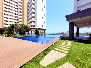 a swimming pool in the middle of a building at PD Seaview Sunset Cozy Staycation With Pool & Netflix, Private Unit in Port Dickson