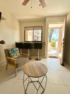 a living room with a piano and a couch at Parakeet Paradise 2nd Floor Condo With Rooftop in Coco