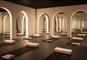 a room with yoga mats in a room with arches at Silvestre Nosara Hotel & Residences in Nosara