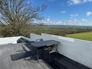 a table and two chairs sitting on a balcony at The Lookout in Wedmore